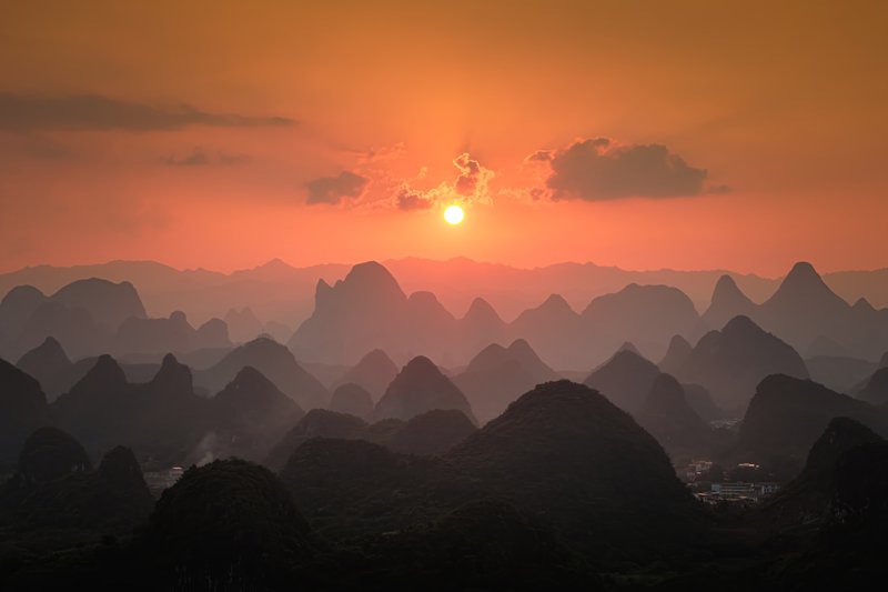 Karst mountain silhouettes at sunset (drone)