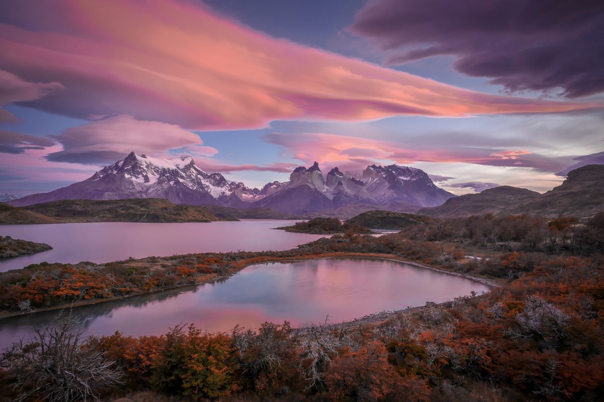 Golden autumn sunset over the vast Patagonian steppe with distant mountain silhouettes