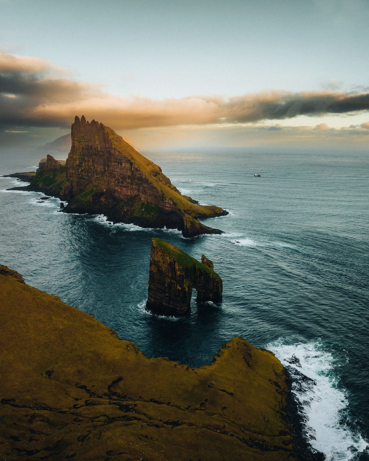 Drangarnir sea stacks rising dramatically from the North Atlantic with Tindholmur Island beyond
